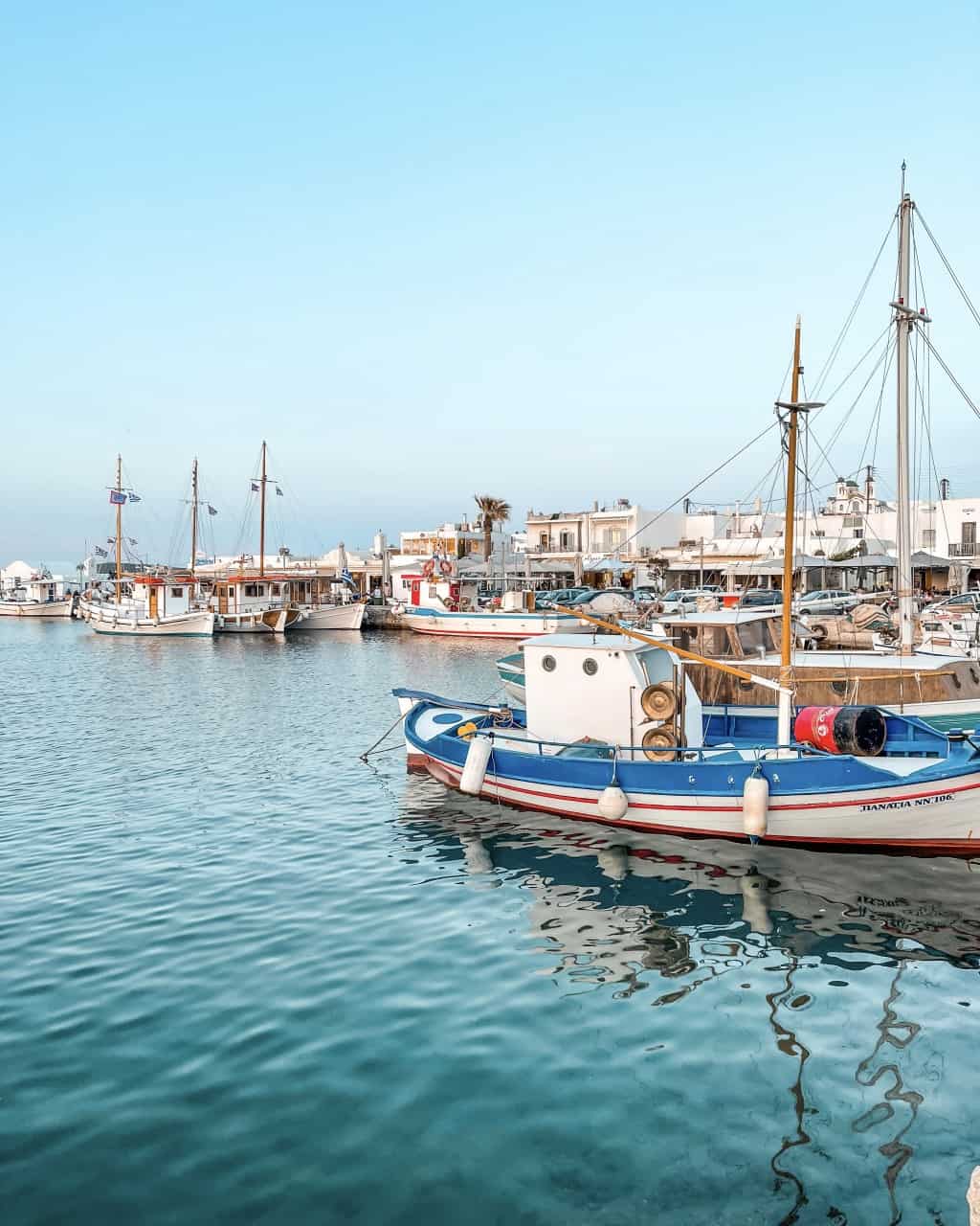 The charming Port of Naoussa in Paros, Greece, adorned with colorful fishing boats