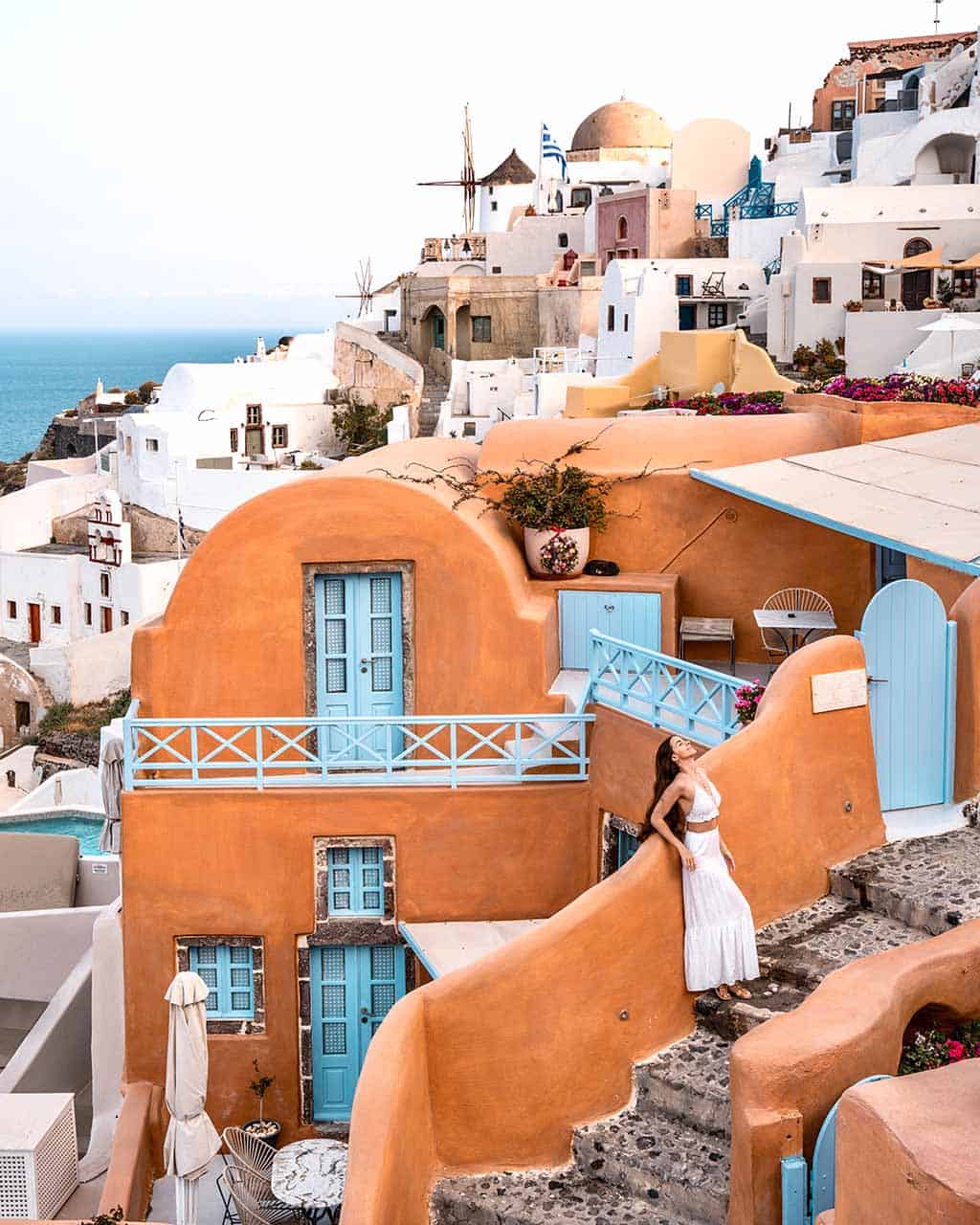 The iconic orange Kastro Oia Houses in Oia, Santorini, built on a hill.