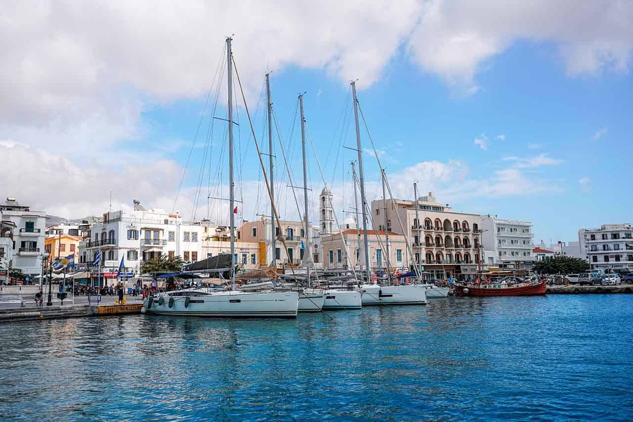 How to get to Tinos: Port in Tinos Town with boats anchored in the water