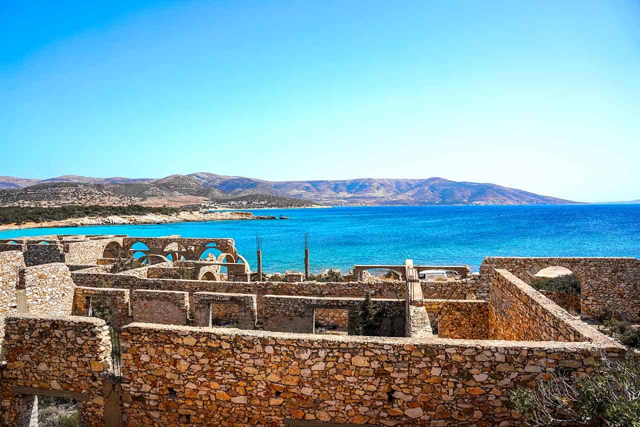 Hotel ruins on the Alyko Peninsula surrounded by azure waters and hills