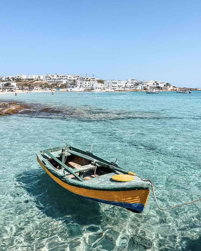 Old fishing boat anchoring in the crystal-clear waters of Ano Koufonisi