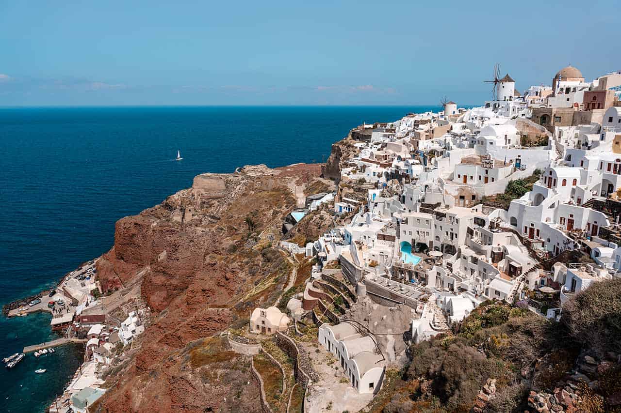 Best Cyclades Island Hopping Itinerary - 3 Weeks in the Cyclades: A scenic view of the whitewashed houses sitting on a cliff above the deep blue Aegean Sea.