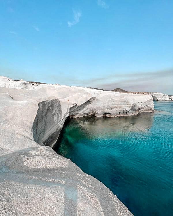 Sarakiniko Beach with its impressive white cliffs contrasting against the vibrant turquoise waters below.