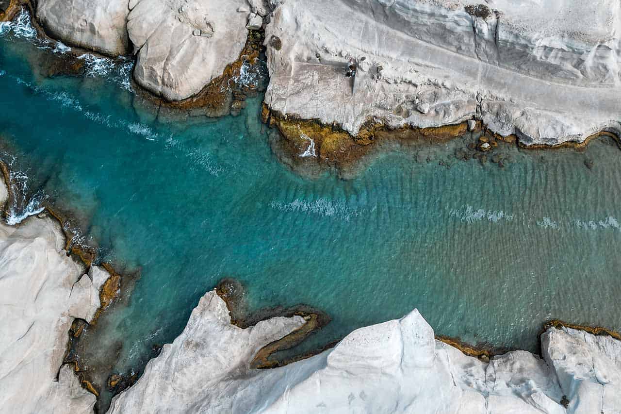 Aerial perspective of the iconic Sarakiniko Beach with its white rocks and turquoise water